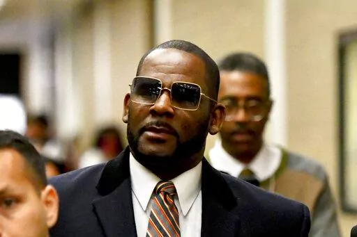 Musician R. Kelly, center, leaves the Daley Center after a hearing in his child support case on May 8, 2019, in Chicago. A Chicago prosecutor said Monday, Jan. 30, 2023, that she's dropping sex-abuse charges against singer R. Kelly, following federal convictions in two courts that ensure the disgraced R&B star will be locked up for decades.(AP Photo/Matt Marton, File)