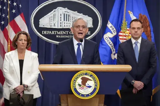 Attorney General Merrick Garland, center, speaks with reporters about an antitrust lawsuit against real estate software company RealPage during a news conference at the Department of Justice, Friday, Aug. 23, 2024, in Washington. At left is Deputy Attorney General Lisa Monaco and at right is Acting Associate Attorney General Benjamin Mizer. (AP Photo/Mark Schiefelbein)