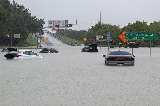 Stalled cars sit abandoned on the flooded Interstate 635 Service Road on Monday, Aug. 22, 2022, in Mesquite, Texas. The National Weather Service issued a flash flood warning early Monday morning which was extended until 1 p.m. (Elías Valverde II/The Dallas Morning News via AP)