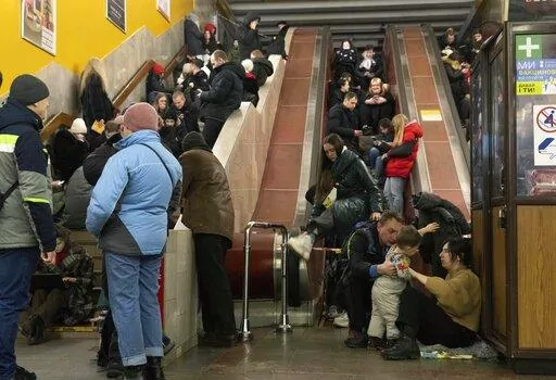 People gather in a subway station being used as a bomb shelter during a Russian rocket attack in Kyiv, Ukraine, Friday, Feb. 10, 2023. (AP Photo/Efrem Lukatsky)