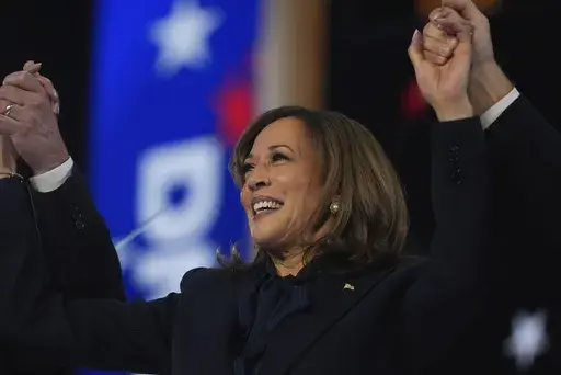 Democratic presidential nominee Vice President Kamala Harris celebrates with her families as the balloons fall during the final day of during the Democratic National Convention Thursday, Aug. 22, 2024, in Chicago. (AP Photo/Erin Hooley)