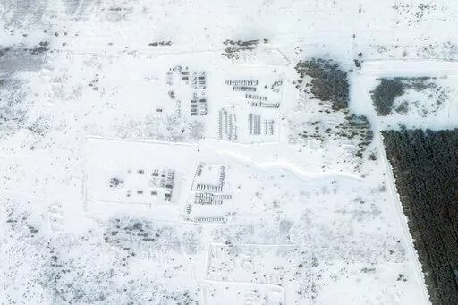 This satellite image provided by Planet Labs PBC shows vehicles and tanks stationed at the Pogonovo training area just south of the city of Voronezh, Russia, Wednesday, Jan. 26, 2022. Russia warned Wednesday it would quickly take "retaliatory measures" if the U.S. and its allies reject its security demands over NATO and Ukraine, raising pressure on the West amid concerns that Moscow is planning to invade its neighbor. (Planet Labs PBC via AP)