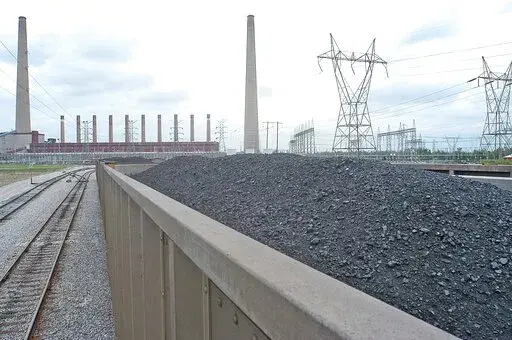 Coal is shown inside one of the train cars headed for the dumping area of the Shawnee Fossil Plant in western McCracken County, Ky. The nation's largest public utility has proposed building a $216 million solar farm project in Kentucky atop a capped coal ash storage pit at one of its coal-fired power plants. The federal Tennessee Valley Authority voted Thursday, Nov. 10, 2022 to advance the initiative at Shawnee Fossil Plant in Paducah. (John Wright/The Paducah Sun via AP)