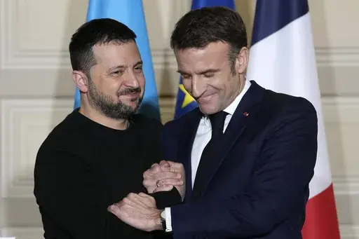 Ukrainian President Volodymyr Zelenskyy, left, and French President Emmanuel Macron shake hands after a press conference, Friday, Feb. 16, 2024 at the Elysee Palace in Paris. Ukrainian President Volodymyr Zelenskyy arrived in Paris to sign a bilateral security agreement with France hours after he officialized a similar one with Germany. The agreements send a strong signal of long-term backing as Kyiv works to shore up Western support nearly two years after Russia launched its full-scale war. (AP