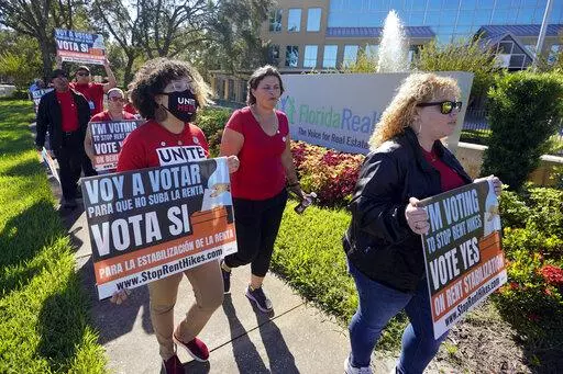Rent control advocates for Orange County demonstrate in front of the Florida Realtors office building on Oct. 22, 2022, in Orlando, Fla. Ballot measures to build more affordable housing and protect tenants from soaring rent increases were plentiful and fared well in last week's midterm elections. The activity reflected growing angst over record high rents exacerbated by inflation and a dearth of homes. (AP Photo/John Raoux, File)