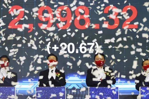 Yoon Suk Yeol, center right, the presidential election candidate of South Korea's main opposition People Power Party (PPP), and Lee Jae-myung, center left, the presidential election candidate of the ruling Democratic Party, attend a ceremony for the first trading day of stock market at the Korea Exchange (KRX) in Seoul, South Korea Monday, Jan. 3, 2022. (Kim Hong-ji/Pool Photo via AP)