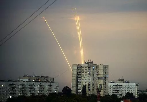 Russian rockets are launched against Ukraine from Russia's Belgorod region at dawn in Kharkiv, Ukraine, Aug. 15, 2022. Eight months after Russian President Vladimir Putin launched an invasion against Ukraine expecting a lightening victory, the war continues, affecting not just Ukraine but also exacerbating death and tension in Russia among its own citizens. (AP Photo/Vadim Belikov, File)