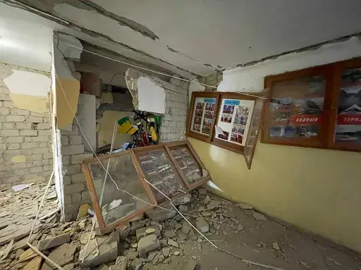 In this photo provided by Yurii Kochubei, a view of the damage after shelling inside a sports complex, in Kharkiv, Ukraine, Saturday, March 5, 2022.  An official in one of Ukraine's pro-Russia separatist region says Russian forces will observe a temporary cease-fire Sunday in two Ukrainian cities. An agreement to allow civilians to evacuate collapsed a day earlier amid continued shelling and the flight of refugees to neighboring nations. (Yurii Kochubei via AP)