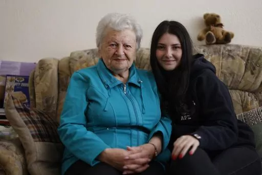 Holocaust survivor Assia Gorban, left, and her granddaughter Ruth Gorban pose during an interview with The Associated Press in Berlin, Germany, Monday, April 3, 2023. Assia Gorman and her granddaughter, 19-year-old Ruth Gorban, are taking part in the new digital campaign Our Holocaust Story: A Pledge to Remember. The campaign launched by the New York-based Conference on Jewish Material Claims Against Germany, also referred to as the Claims Conference, features survivors and their descendants fro