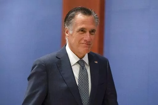 Sen. Mitt Romney, R-Utah, arrives to watch a speech by Ukrainian President Volodymyr Zelenskyy live-streamed into the U.S. Capitol, in Washington, March 16, 2022. Bipartisan Senate bargainers have agreed to a slimmed-down $10 billion package for countering COVID-19, but without any funds to help nations abroad combat the pandemic, Democrats and Republicans familiar with the talks said Monday, April 4. (AP Photo/Alex Brandon, File)