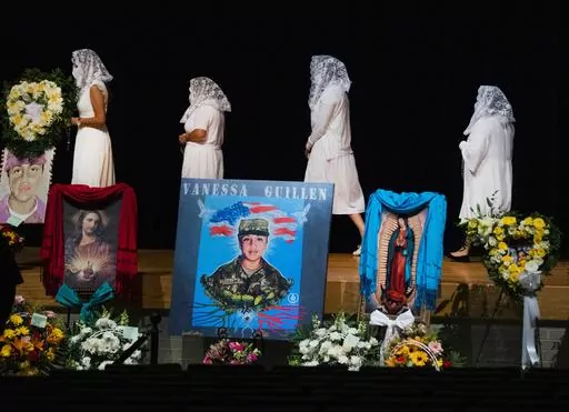 Ladies from the Queen of Peace Church walk to the stage to pray the rosary during the memorial service of U.S. Army Specialist Vanessa Guillén at the Cesar Chavez High School on Aug. 14, 2020, in Houston. A federal judge has sentenced a Texas woman Monday, Aug. 14, 2023, to 30 years in prison for helping to dispose of the body of U.S. soldier Guillén. The 2020 killing led to changes in how women in the military can report sexual abuse. (Marie D. De Jesus/Houston Chronicle via AP, Pool, File)