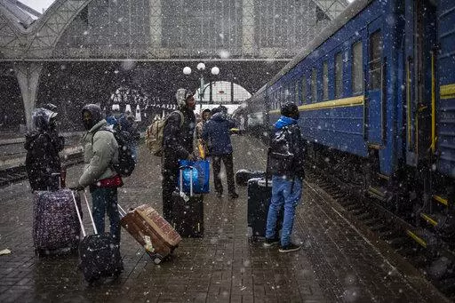 Nigeria students in Ukraine wait at the platform in Lviv railway station, Feb. 27, 2022, in Lviv, west Ukraine. Jarred by discriminatory treatment and left to evacuate themselves from Ukraine, people from African, Asian and Latin American countries who succeed in getting out are forming impromptu networks to help thousands of others hoping to flee. (AP Photo/Bernat Armangue, File)