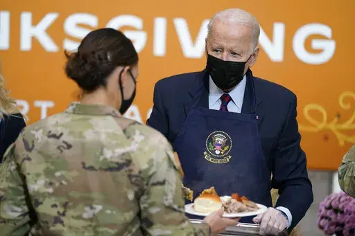 President Joe Biden serves dinner during a visit to soldiers at Fort Bragg to mark the upcoming Thanksgiving holiday, Monday, Nov. 22, 2021, in Fort Bragg, N.C. (AP Photo/Evan Vucci)