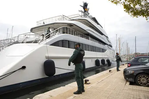 Civil Guards stand by the yacht called Tango in Palma de Mallorca, Spain, Monday April 4, 2022. U.S. federal agents and Spain's Civil Guard are searching the yacht owned by a Russian oligarch.  The United States and allies are again escalating sanctions against Russia, Wednesday, April 6, after evidence that Russian troops murdered Ukrainian civilians in a town near Kyiv.  (AP Photo/Francisco Ubilla, File)