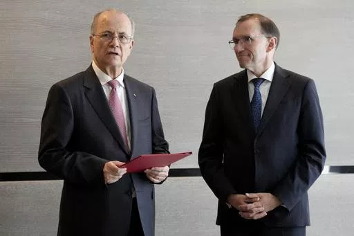 Prime Minister of the Palestinian Authority Mohammed Mustafa, left, speaks after receiving a document handed over by Norway's Foreign Minister Espen Barth Eide, right, prior to a meeting for talks on the Middle East in Brussels, Sunday, May 26, 2024. Norway on Sunday handed over papers to the Palestinian prime minister to officially give it diplomatic recognition as a state in a largely symbolic move that has infuriated Israel. The formal recognition by Norway, Spain and Ireland, which all have 