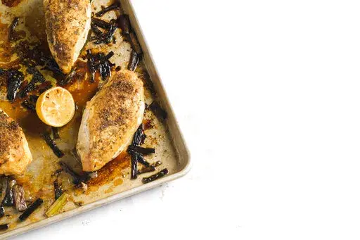 This image released by Milk Street shows a recipe for Fennel-Crusted Chicken & Scallion Traybake. (Milk Street via AP)