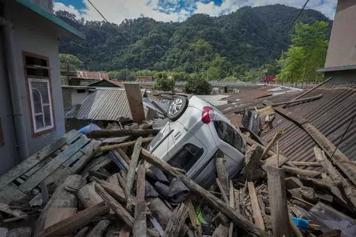 A vehicle lies in the debris of damaged houses in the flood affected area along the Teesta river in Rongpo, east Sikkim, India, Sunday, Oct. 8. 2023. Rescuers continued to dig through slushy debris and ice-cold water in a hunt for survivors after a glacial lake burst through a dam in India’s Himalayan northeast, shortly after midnight Wednesday, washing away houses and bridges and forcing thousands to flee. (AP Photo/Anupam Nath)