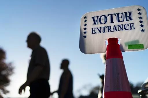 Voters pass a sign outside a polling site in Warwick, R.I., on Nov. 7, 2022. With the Republican primaries around the corner, a new poll finds that party members aren't sure votes in the presidential nominating contest will be counted accurately. Only about one-third of Republicans say they're confident that tallies in the primary will be accurate. That's according to a new AP-NORC poll. (AP Photo/David Goldman, File)