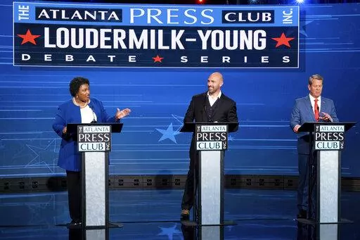 Democratic challenger Stacey Abrams, from left, Libertarian challenger Shane Hazel and Georgia Republican Gov. Brian Kemp debate during the Atlanta Press Club Loudermilk-Young Debate Series in Atlanta, Monday, Oct. 17, 2022. (AP Photo/Ben Gray)