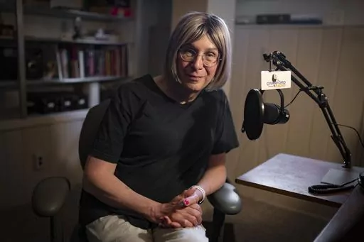 Bernie Wagenblast sits for a photo at her home, Friday, June 16, 2023, in Cranford, N.J. As culture wars erupt anew in the United States over sex and gender, Wagenblast is exchanging that voice for a new one, with a pitch and cadence that reflects a transition from being the man he was to the woman she is becoming. (AP Photo/John Minchillo)