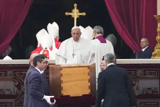 Pope Francis, centre, sits as the coffin of late Pope Emeritus Benedict XVI St. Peter's Square is carrying during a funeral mass at the Vatican, Thursday, Jan. 5, 2023. Benedict died at 95 on Dec. 31 in the monastery on the Vatican grounds where he had spent nearly all of his decade in retirement. (AP Photo/Alessandra Tarantino)