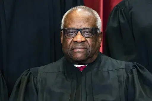 Justice Clarence Thomas sits during a group photo at the Supreme Court in Washington, on Friday, April 23, 2021. Thomas has been hospitalized because of an infection, the Supreme Court said Sunday, March 20, 2022. Thomas, 73, has been at Sibley Memorial Hospital in Washington, D.C., since Friday, March 18 after experiencing “flu-like symptoms,” the court said in a statement. (Erin Schaff/The New York Times via AP, Pool, File)