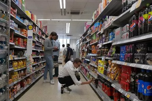 Shoppers buy food in a supermarket in London, Wednesday, Aug. 17, 2022. Britain’s new Prime Minister Liz Truss has pledged to rebuild the economy, but she faces a daunting job. Truss inherits an ailing economy on the brink of a potentially long recession, with record inflation and millions crying out for government help to cope with energy bills. (AP Photo/Frank Augstein, File)