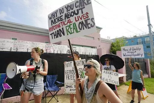 Abortion rights advocates stand outside the Jackson Women's Health Organization clinic in Jackson, Miss., and attempt to shout down a group of abortion opponents, Thursday, July 7, 2022. The clinic was the only facility that performed abortions in the state. However, on Tuesday, a chancery judge rejected a request by the clinic to temporarily block a state law banning most abortions. Without other developments in the Mississippi lawsuit, the clinic ceased abortions the end of business Wednesday 