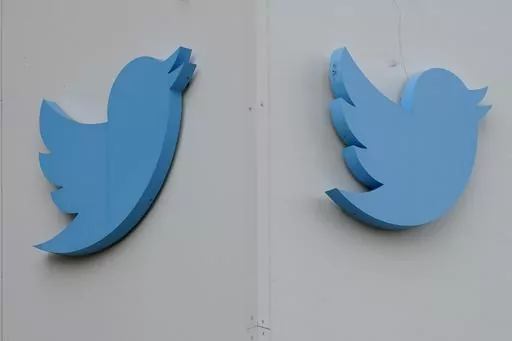 Twitter logos hang outside the company's offices in San Francisco, Monday, Dec. 19, 2022. Ella Irwin, a top Twitter executive responsible for safety and content moderation, has left the company. Her departure came after owner Elon Musk publicly complained about the platform’s handling of posts about transgender topics. (AP Photo/Jeff Chiu, File)