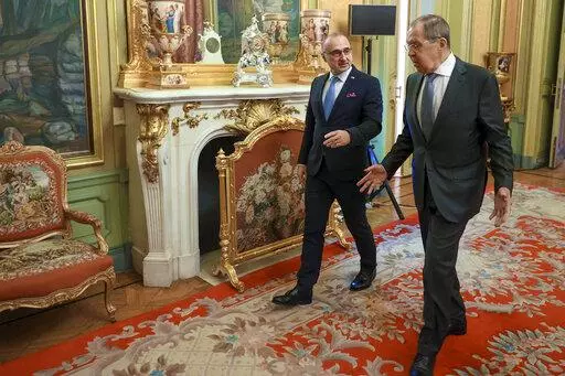In this photo provided by the Russian Foreign Ministry Press Service, Russia's Foreign Minister Sergey Lavrov, right, and Croatia's Foreign Minister Gordan Grlic Radman walk together ahead of their talks in Moscow, Russia, Monday, Jan. 17, 2022. (Russian Foreign Ministry Press Service via AP)