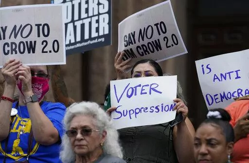 Demonstrators join a rally to protest proposed voting bills on the steps of the Texas Capitol on July 13, 2021, in Austin, Texas. A sweeping new Texas voting law that Republicans muscled through the Legislature last year over dramatic protests is drawing fire again, even before some of the most contentious restrictions and changes kick in ahead of the state's first-in-the nation primary. (AP Photo/Eric Gay, File)