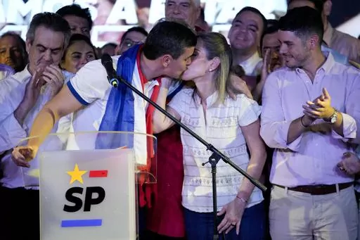 Santiago Peña, presidential candidate of the Colorado ruling party, kisses his wife Leticia Ocampos after the voting closed during general elections in Asuncion, Paraguay, Sunday, April 30, 2023. (AP Photo/Jorge Saenz)