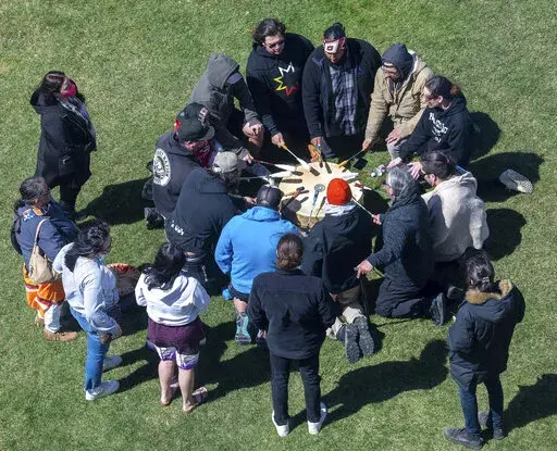 A group of singers from the Wabanaki Confederacy drum and sing before a news conference in support of the tribal sovereignty bills Wednesday, April 20, 2022, in front of the Maine State House in Augusta, Maine. (Joe Phelan/The Kennebec Journal via AP)