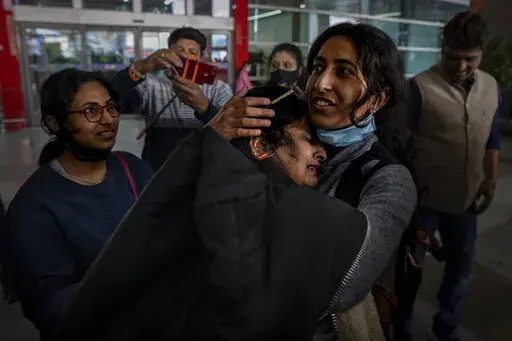 Mansi Singhal, an Indian student studying in Ukraine who fled the conflict, hugs her mother after she arrived at Indira Gandhi International Airport in New Delhi, India, Wednesday, March 2, 2022. (AP Photo/Altaf Qadri)