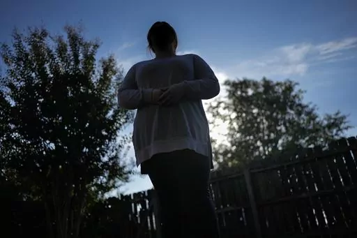 Ramona stands for a portrait Tuesday, Oct. 10, 2023, in Cordova, Tenn. The COVID-19 pandemic, and the conspiracy theories it spawned, would change Ramona's life forever, sending her down a dark path of paranoia and isolation. (AP Photo/George Walker IV)