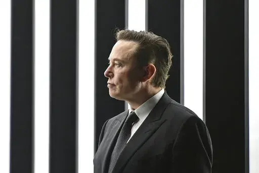 Elon Musk, Tesla CEO, attends the opening of the Tesla factory Berlin Brandenburg in Gruenheide, Germany, March 22, 2022. Musk, the world's richest man and the owner of SpaceX and Tesla, says he is a free speech absolutist who doesn't support the kind of content moderation that saw people like ex-President Donald Trump get banned for inciting violence (Patrick Pleul/Pool via AP, File)