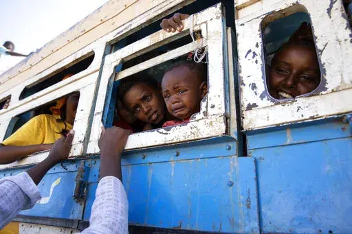 Refugees who fled the conflict in Ethiopia's Tigray region ride a bus going to the Village 8 temporary shelter, near the Sudan-Ethiopia border, in Hamdayet, eastern Sudan on Dec. 1, 2020. Widespread abuses against civilians in the western part of Ethiopia's embattled Tigray region amount to war crimes and crimes against humanity, Human Rights Watch and Amnesty International have charged in a new report Wednesday, April 6, 2022. (AP Photo/Nariman El-Mofty, File)
