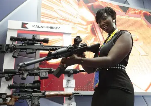A visitor handles a gun at an exhibition by the Kalashnikov company on the sidelines of the Russia-Africa summit in the Black Sea resort of Sochi, Russia on Oct. 24, 2019. Amid a worldwide chorus of condemnation against Russia's war on Ukraine, Africa has remained mostly quiet — a reminder of the Kremlin's considerable influence over the continent. (Sergei Chirikov, Pool Photo via AP, File)