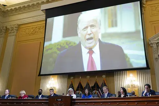 A video of President Donald Trump is shown on a screen, as the House select committee investigating the Jan. 6 attack on the U.S. Capitol holds a hearing at the Capitol in Washington, July 21, 2022. The House committee investigating the Capitol riot will hold its final meeting Monday, Dec. 19, wrapping up its year-and-a-half-long inquiry by asking the Justice Department to investigate potential crimes. (AP Photo/J. Scott Applewhite, File)