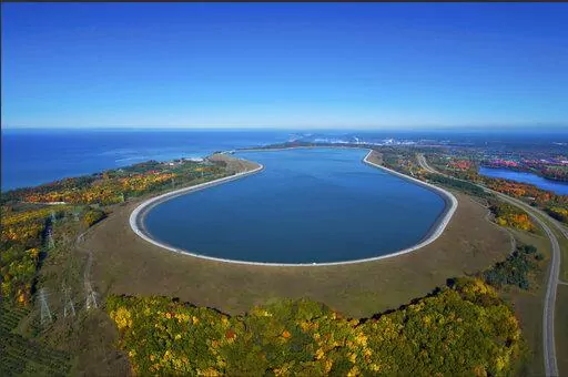 This undated photo provided by Consumers Energy shows an aerial view of the Ludington Pumped Storage Plant near Ludington, Mich. The plant generates electricity by pumping water from Lake Michigan to a reservoir on top of a bluff, then releasing it through giant turbines as needed. Advocates of pumped storage call such facilities the "world's largest batteries." (AP Photo/Consumers Energy)