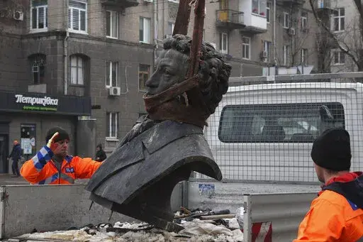 In this photo released by the Dnipro Region Administration, Municipal workers dismantle a monument of Russian writer Alexander Pushkin in the city centre of Dnipro, Ukraine, Friday, Dec. 16, 2022. Ukraine is accelerating efforts to erase the vestiges of centuries of Soviet and Russian influence from the public space by pulling down monuments and renaming hundreds of streets to honor home-grown artists, poets, military chiefs, and independence leaders, even heroes of this year's war. (Dnipro Regi