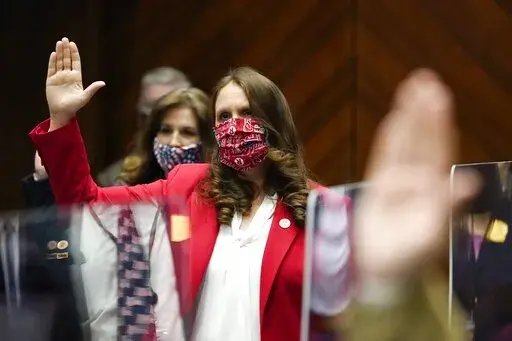 Rep. Michelle Udall, R-Mesa, is sworn in during the opening of the Arizona Legislature at the state Capitol Monday, Jan. 11, 2021, in Phoenix. Udall defected from a united GOP front on Thursday, Feb. 24, 2022, to defeat a measure that would have banned manufacturing or prescribing medication that would cause an abortion. The bill that unexpectedly failed would have eliminated the choice used by half of the people who have abortions in the state, leaving a surgical procedure as the only option. "