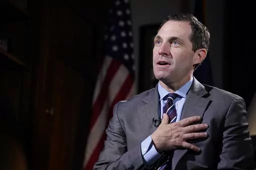 Rep. Jason Crow, D-Colo., talks during an interview with The Associated Press in his office on Capitol Hill in Washington, Dec. 15, 2021. Two decades ago, Crow was a 24-year-old platoon leader in the American invasion of Iraq. Platoon members carried gas masks and gear to wear over their uniforms to protect them from the chemical weapons the U.S. believed – wrongly – that Iraqi forces might use against them. Today, Crow sits on committees that oversee the U.S. military and intelligence agenc