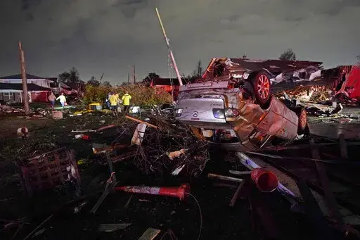 A car is flipped over after a tornado tore through the area in Arabi, La., Tuesday, March 22, 2022, in a part of the city that had been heavily damaged by Hurricane Katrina 17 years earlier. A United Nations report released on Monday, April 25, 2022, says disasters are on the rise are just going to get worse. A new UN report says the number of disasters, from climate change to COVID-19, are going to jump to about 560 a year by 2030. (AP Photo/Gerald Herbert, File)