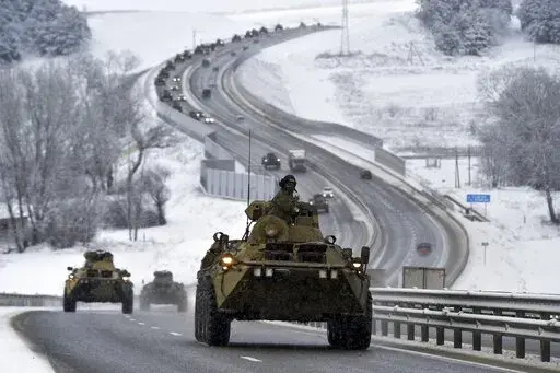 A convoy of Russian armored vehicles moves along a highway in Crimea, Tuesday, Jan. 18, 2022. Russia has concentrated an estimated 100,000 troops with tanks and other heavy weapons near Ukraine in what the West fears could be a prelude to an invasion. The Biden administration is unlikely to answer a further Russian invasion of Ukraine by sending U.S. combat troops. But it could pursue a range of less dramatic yet still risky options, including giving military support to a post-invasion Ukrainian
