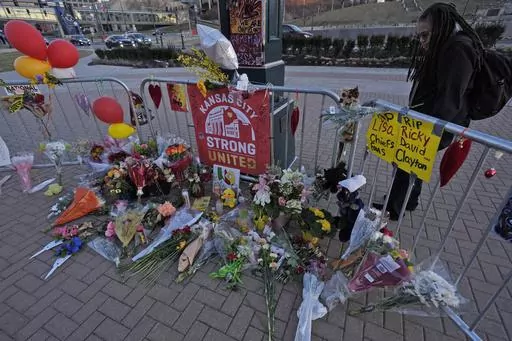 A person views a memorial dedicated to the victims of last week's mass shooting in front of Union Station, Sunday, Feb. 18, 2024, in Kansas City, Mo. Missouri prosecutors said Tuesday, Feb. 20, that two men have been charged with murder in last week’s shooting that killed one person and injured multiple others after the Kansas City Chiefs’ Super Bowl parade. (AP Photo/Charlie Riedel, File)