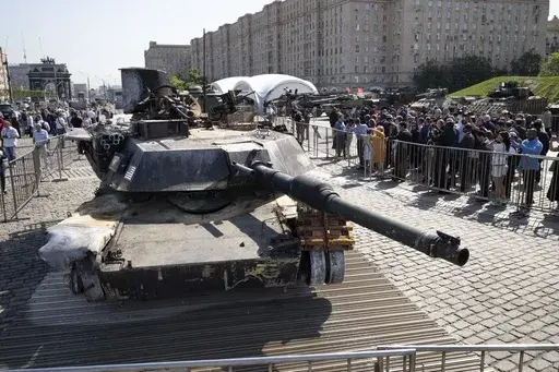 Representatives of the diplomatic corps look at U.S.-made M1 Abrams tank, and other U.S. military vehicles, hit and captured by Russian troops during the fighting in Ukraine as they visit an exhibition of Western military equipment seized from Ukrainian forces, in Moscow, on Friday, May 31, 2024. The exhibit, organized by the Russian Defense Ministry, features more than 30 pieces of Western-made heavy equipment, including a U.S.-made M1 Abrams tank and a Bradley armored fighting vehicle. (AP Pho