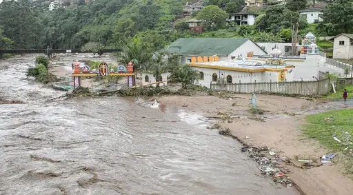 Floodwaters wash through a property near Durban, South Africa, Tuesday, April 23, 2019. The fatal floods that wreaked havoc in South Africa in mid-April this year have been attributed to climate change, an analysis published Friday, May 13, 2022 by a team of leading climate scientists said.The World Weather Attribution group analyzed both historical and emerging sets of data from the catastrophic rainfall that led to floods which triggered massive landslides in the Eastern Cape and Kwa-Zulu Nata