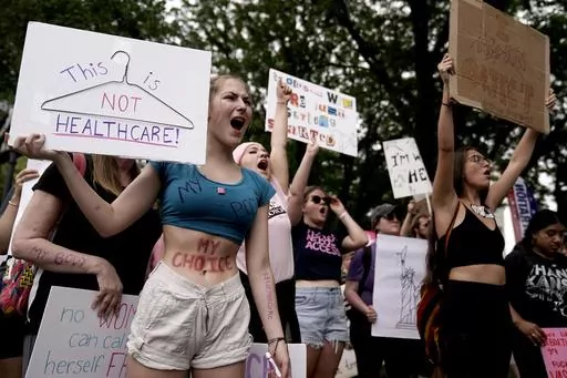 People rally in support of abortion rights, July 2, 2022, in Kansas City, Mo. A divide between abortion rights activists over whether to include restrictions related to the viability of the fetus on planned state ballot measures is roiling the movement. The conflict has been especially divisive in Missouri, where conflicting strategies are complicating efforts to push ahead with a ballot measure in a state with one of the nation's strictest abortion bans. (AP Photo/Charlie Riedel, File)