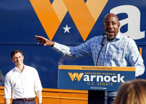 U.S. Sen. Raphael Warnock, D-Ga., speaks at a campaign event in Clarkston, Ga., on Thursday, Nov. 3, 2022. At left is U.S. Sen. Jon Ossoff, D-Ga. Herschel Walker and Sen. Raphael Warnock meet Tuesday, Nov. 8, in Georgia’s Senate contest that could help determine which party controls the Senate for the next two years. More than 2.5 million Georgia voters have already cast ballots, about a 20% increase over advanced voting in 2018. (AP Photo/Bob Andres, File)